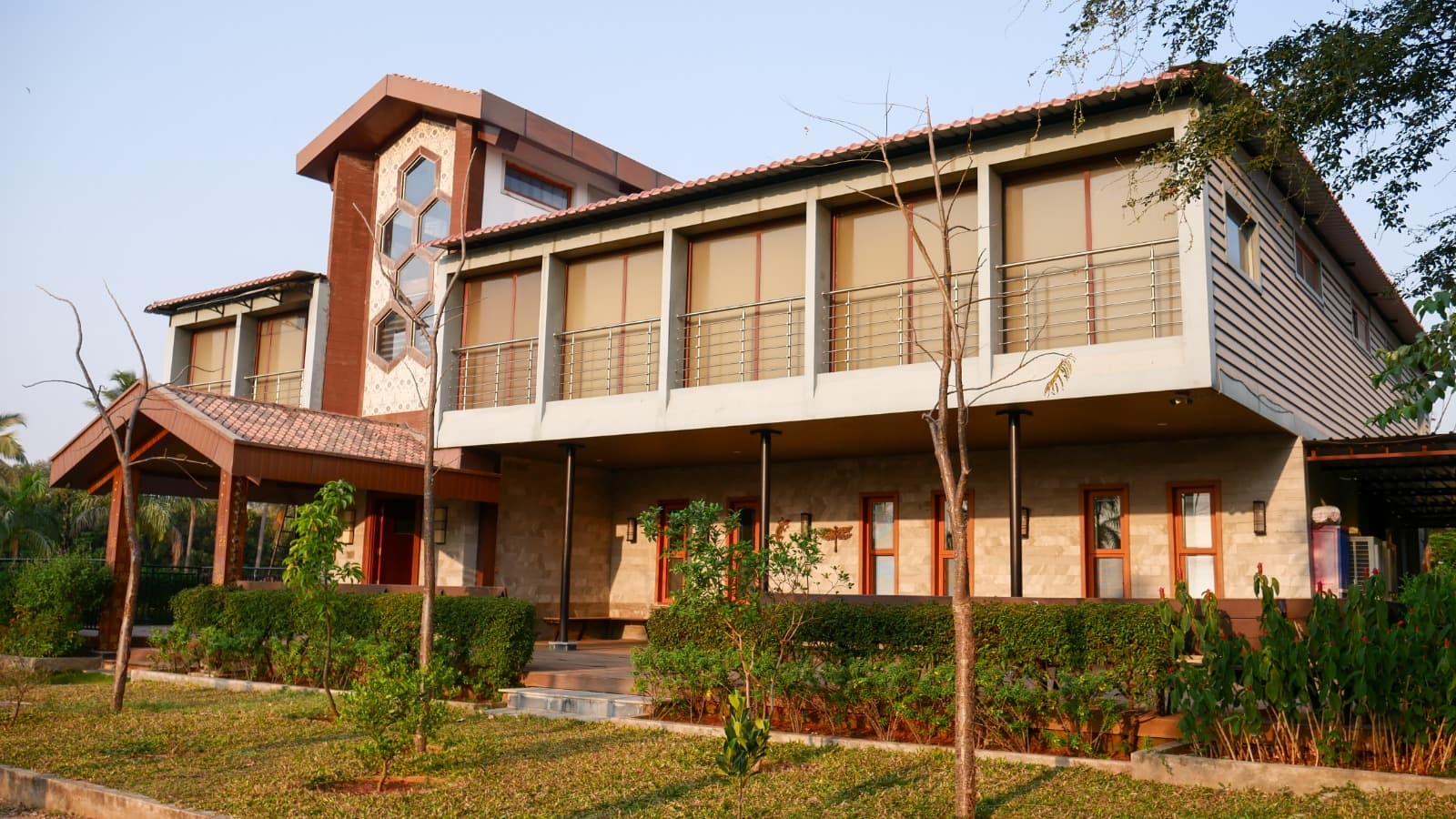 Farmhouse exterior with covered verandas, built by Lands & Riches